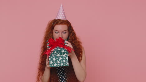 Cheerful-young-redhead-woman-opening-gift-box,-unwrapping-birthday-surprise-and-expressing-happiness