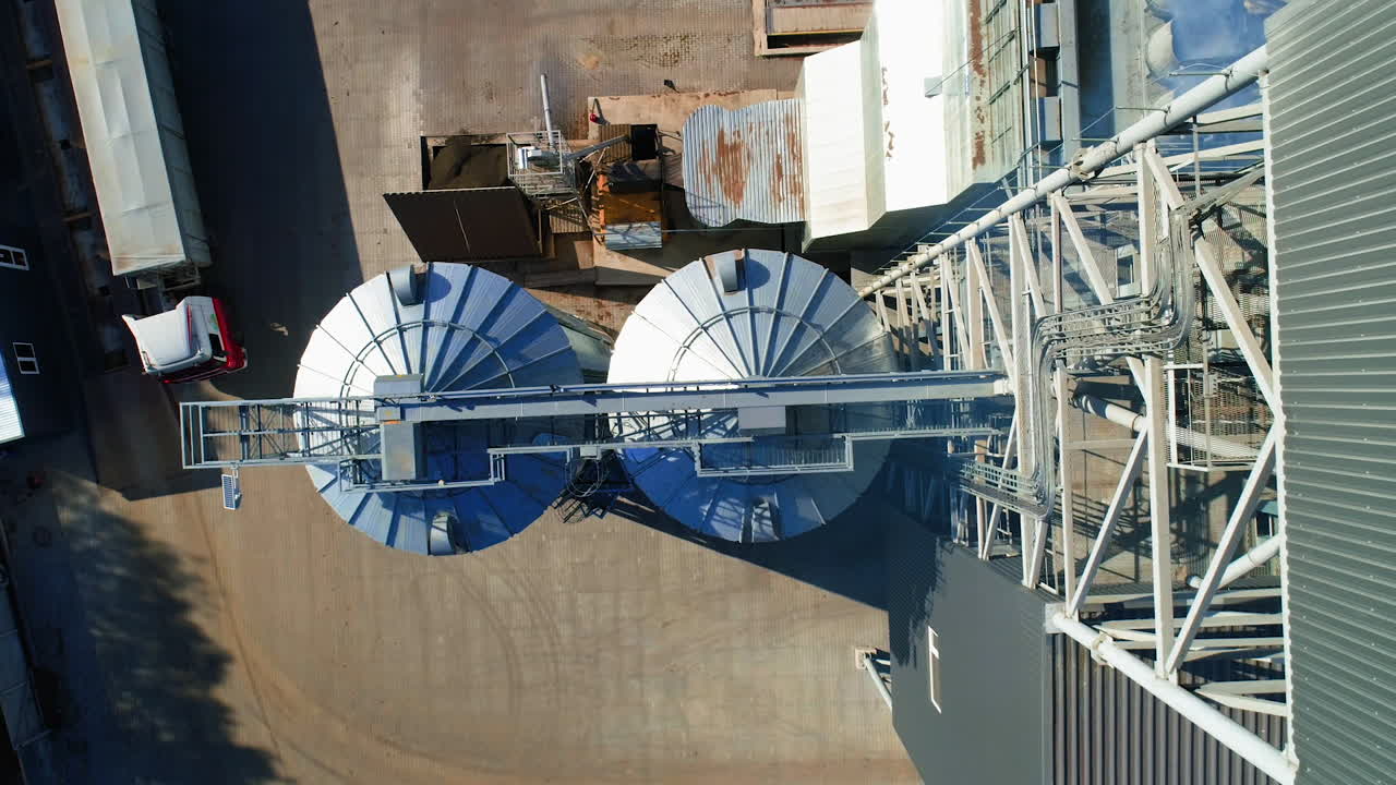 Grain Cooperative. Large aluminum containers for storing loose grain. Aerial view