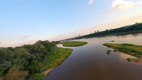 fpv drone shot of gdanski bridge built over scenic vistula river at sunset, warsaw, poland