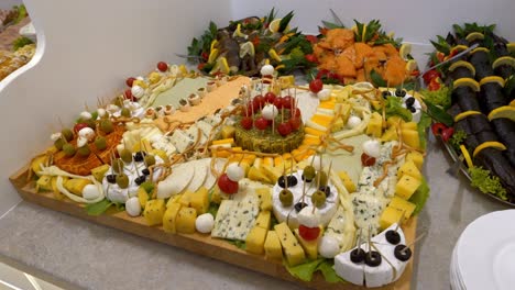 cheese board adorned with cherry tomatoes, olives, and mozzarella balls