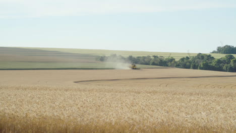 Great-wide-shot-of-a-seeder-tractor-harvesting-soybeans-in-the-country