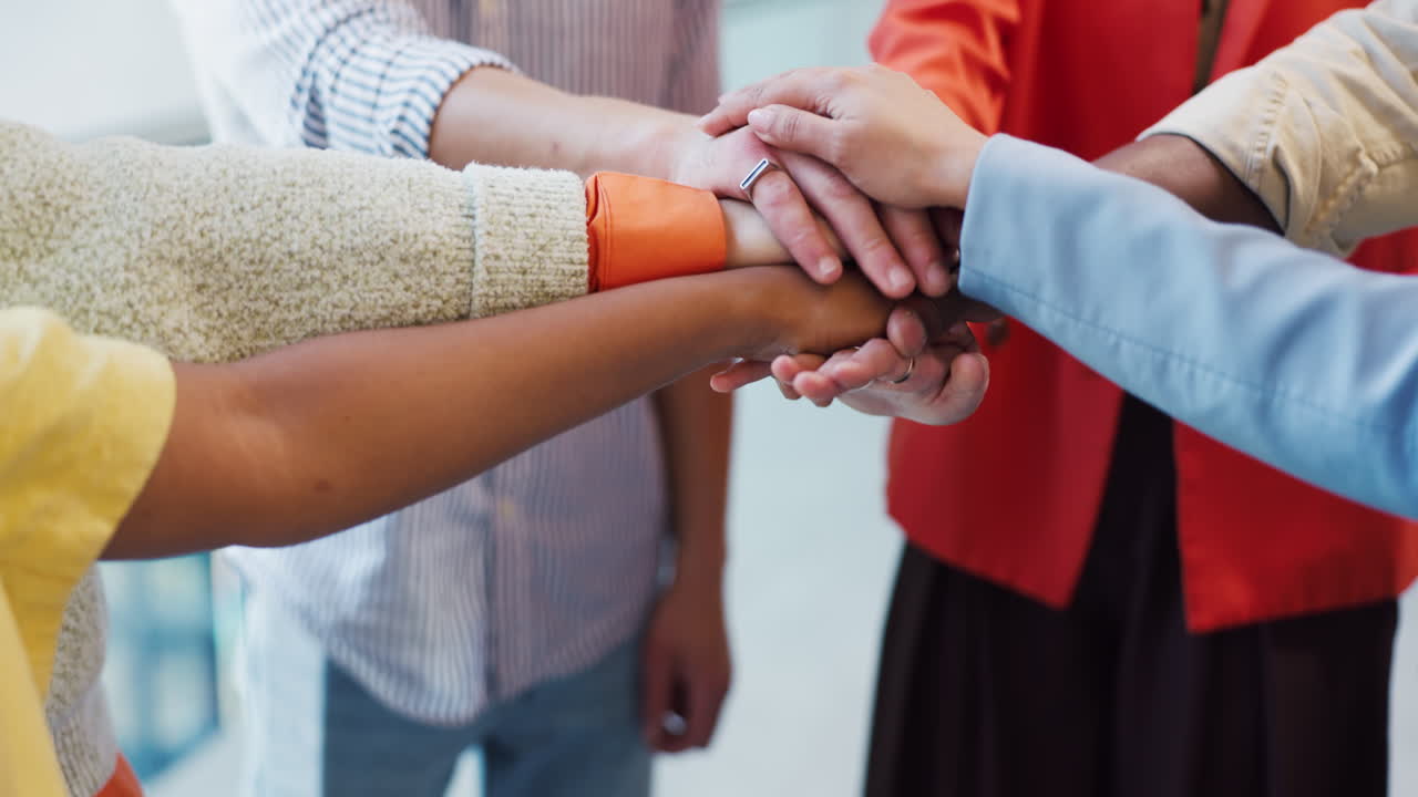 Diverse Business Team Huddling Hands and Clapping