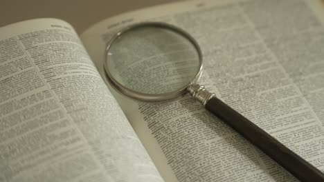 magnifying glass on large opened book