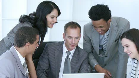 business people working together in office with a laptop