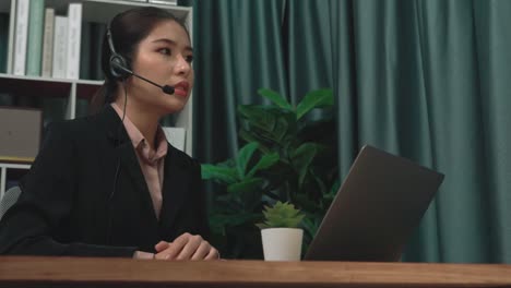 enthusiastic businesswoman utilizing laptop for video conference.