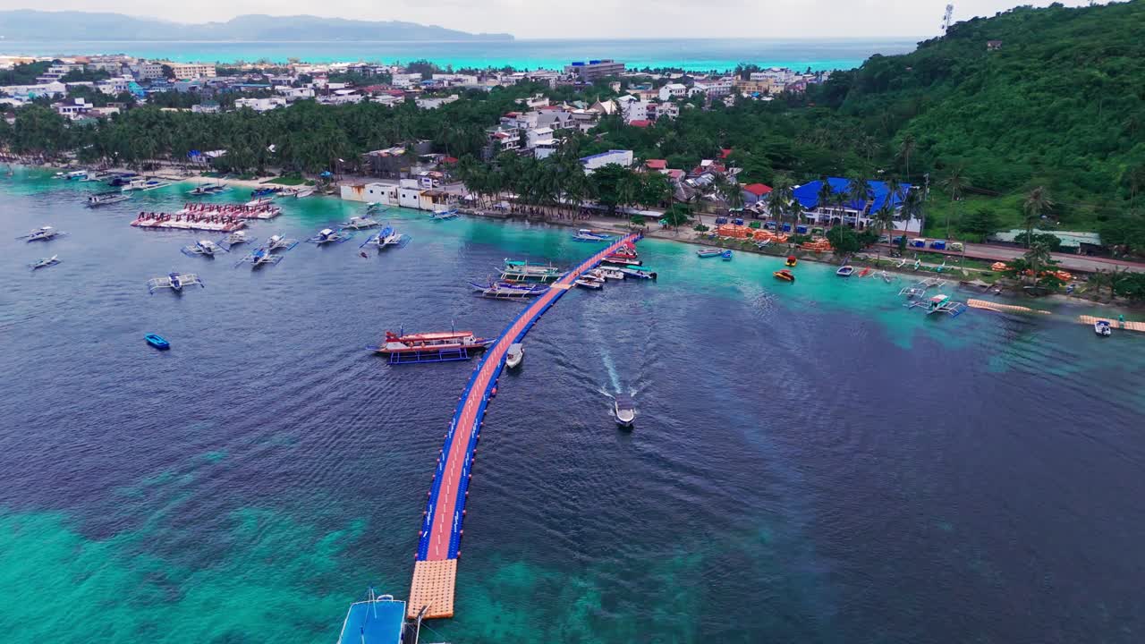 Stunning 4K drone footage of Boracay Jetty Port, vibrant turquoise waters, and coastal townscape in the Philippines—perfect for travel, tourism, and tropical destination projects