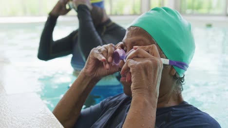 video of happy senior african american couple swimming