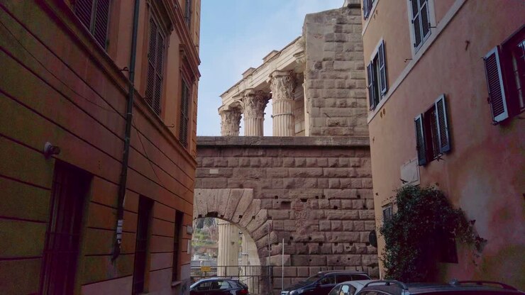 Walking in the roman district of Monti, in a narrow street leading to Forum of Augustus with its columns from ancien Rome
