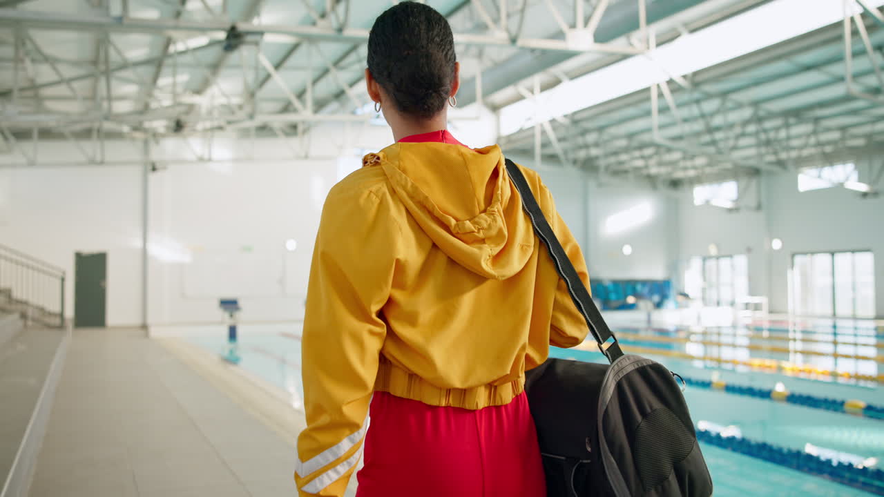 Woman walking toward swimming pool