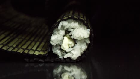 closeup of a sushi roll on bamboo mat