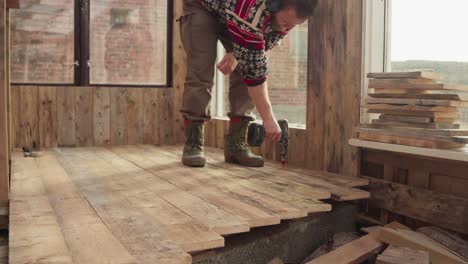 Man-Using-Power-Tool-Drill-In-Building-His-Greenhouse---Close-Up