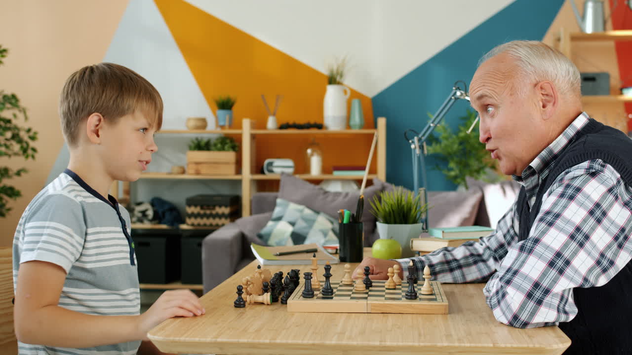 Grandparent and Grandchild Playing Chess
