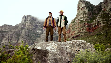 two elderly men hiking in the mountains
