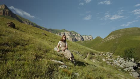 woman sitting on a mountainside