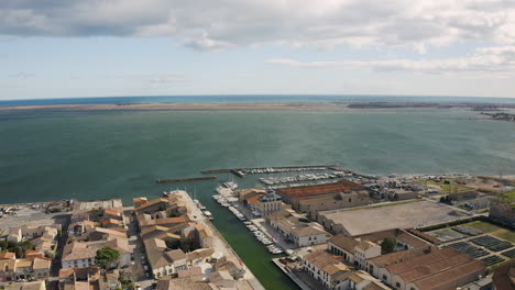 Back-aerial-traveling-over-Marseillan-town-tabarka-shellfish-port-sunny-day