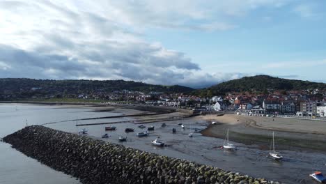 North-Wales-seaside-town-seafront-coastline-hotels-harbour-breakwater-aerial-view-low-orbit-right