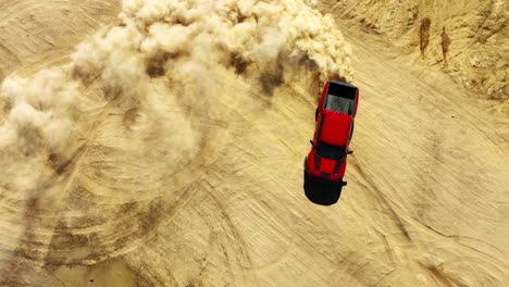 truck in the desert spinning a circle and causing a huge dust plume - aerial view