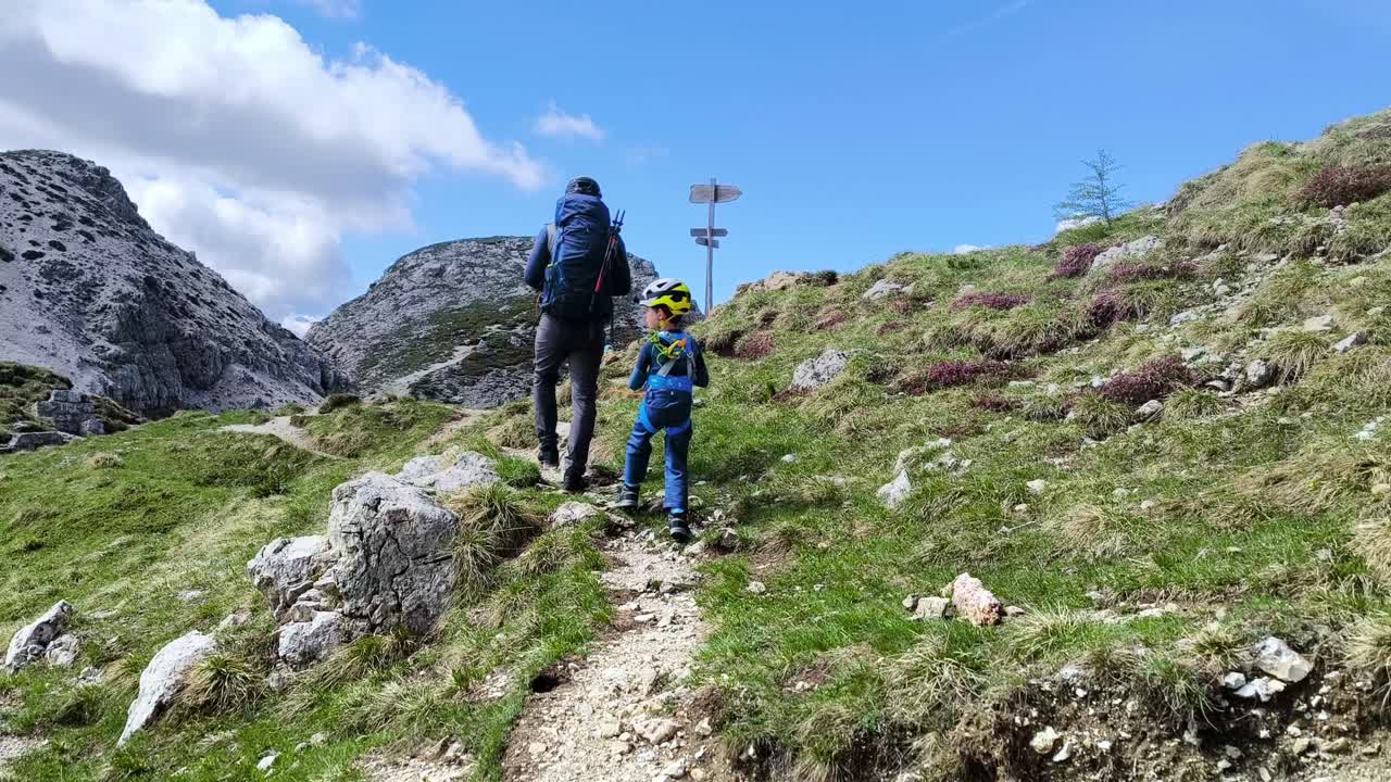 Hikers making their way to Sasso di Stria in Alta Badia Dolomites, Italy, with rocky trails and majestic mountain peaks
