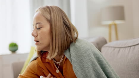 asian woman on couch, sneeze