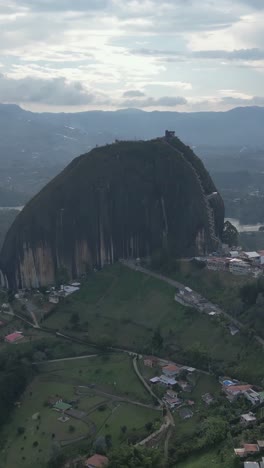 panoramic drone views of el peñon de guatape, a unique rock with stairs, vertical mode