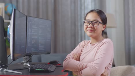 smiling teenager coding at home