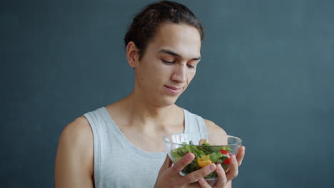 young man eating salad