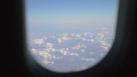 view to the clouds and land from flying airplane