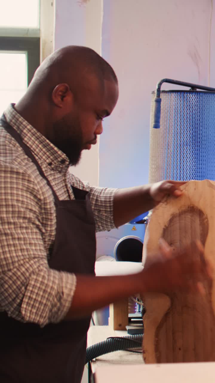African American Man Sanding Wood in a Workshop