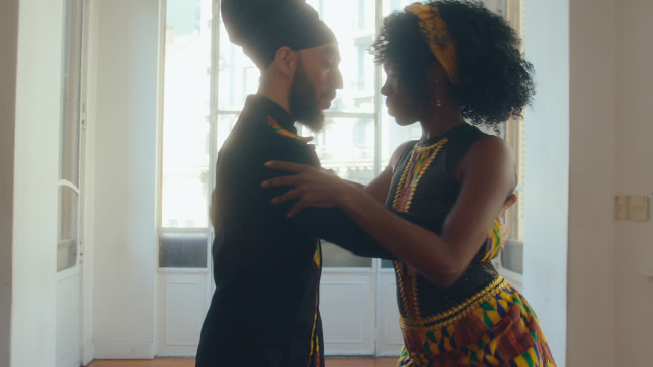 Artistic Couple in Stage Costumes Dancing Argentine Tango in Studio