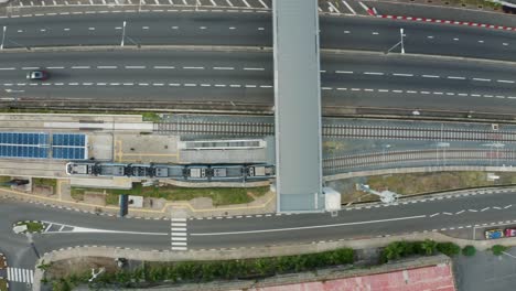 Aerial-tracking-shot-of-driving-metro-express-on-rail-at-Victoria-Urban-terminal-in-Mauritius