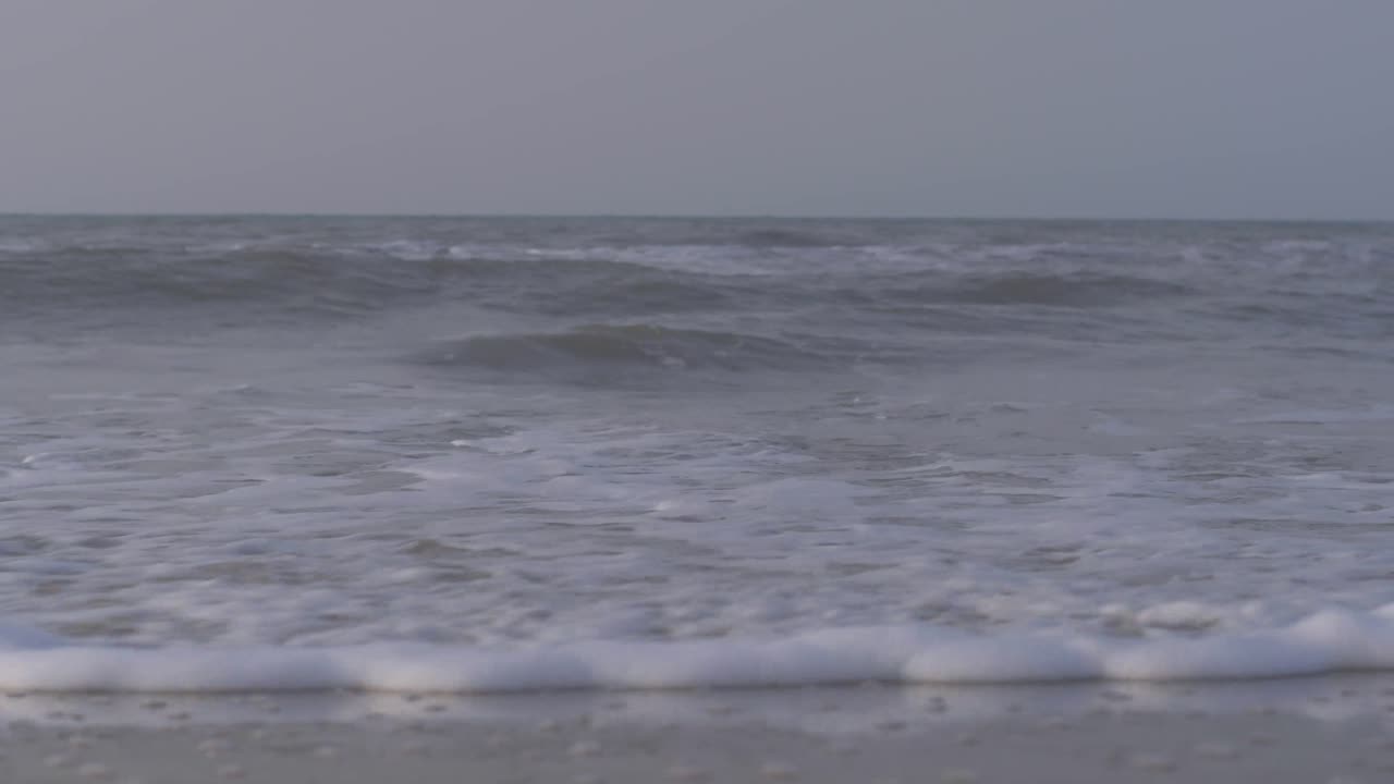 Waves of the caribbean sea breaking on the shore of the sandy beach