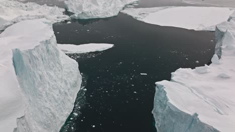 drone over sea and ice of ilulissat icefjord