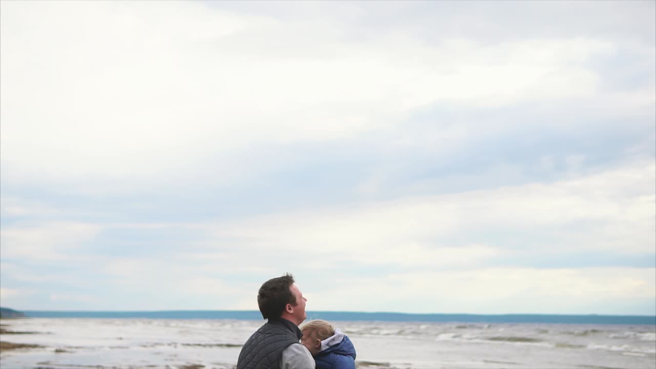 Father playing with his child on the beach