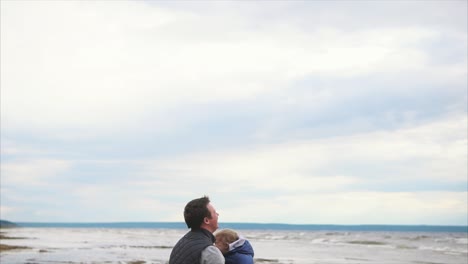 father playing with his child on the beach