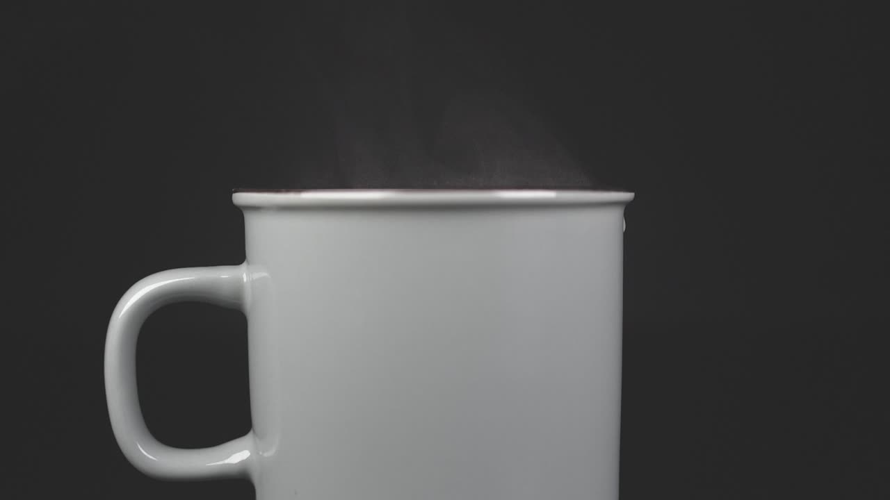 Filling cup with hot water with vapour, slow motion 4K