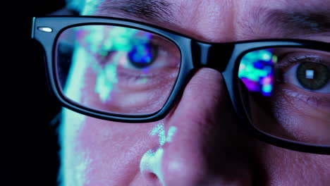 close-up of eyes with digital data reflections in glasses