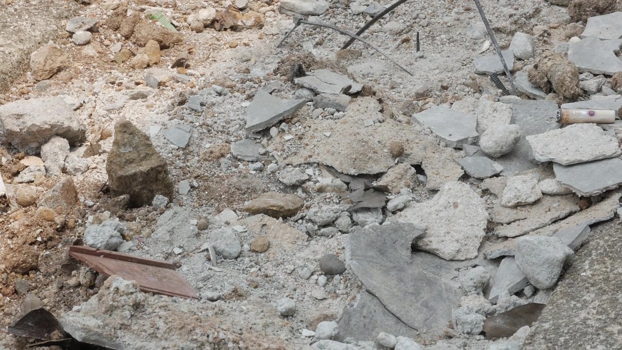 Construction Debris and Broken Concrete Rubble on the Ground