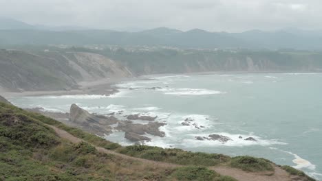 general view of the cliffs of cabo vidio, with a trail, in asturias