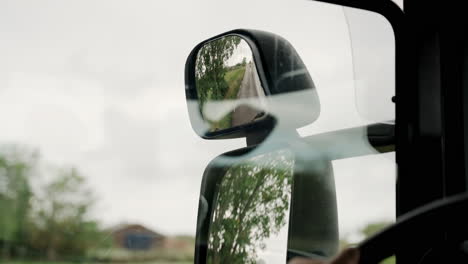 cerrar espejo vidrio reflexión reflexivo campos abiertos lado ángulo de visión camión autobús conductor conducción rápido paisaje viaje viaje visitando destino mirando hacia atrás cinturón de seguridad carretera calle autopista