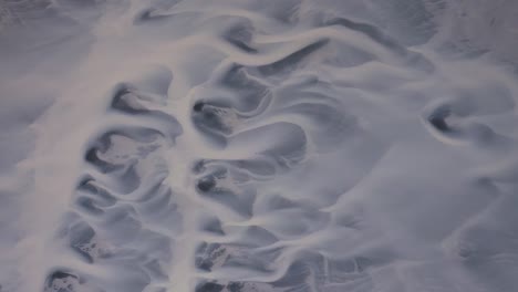 aerial top down shot sandy terrain with braided river on iceland, europe