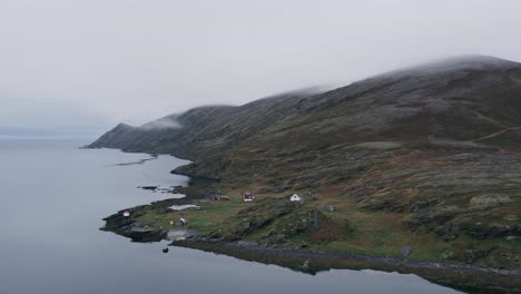 Raw and serene beauty of a remote fjord, surrounding mountains under a misty sky