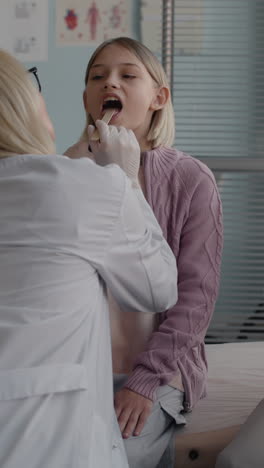 girl having a throat examination at the doctor's office