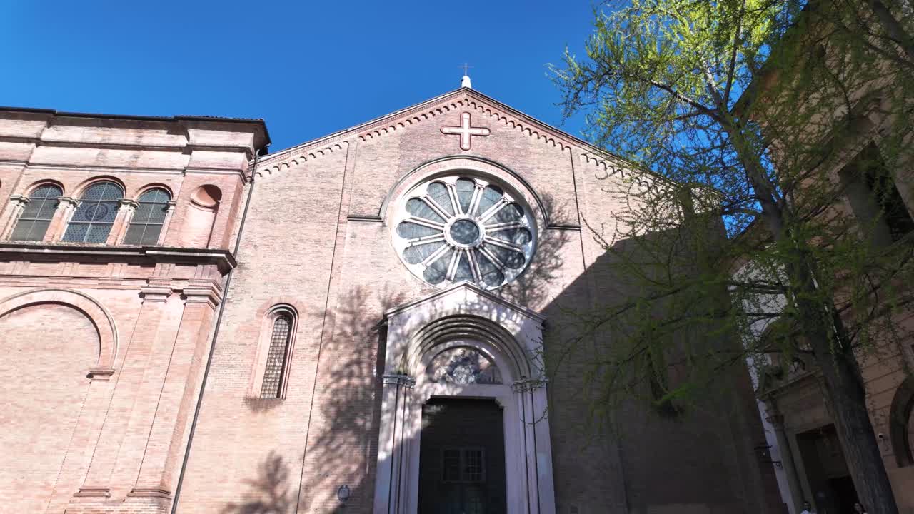 Facade of a historic brick church with a large rose window
