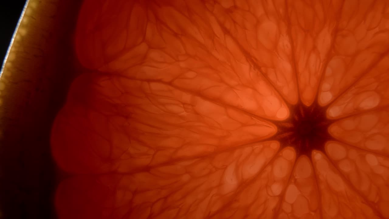 Organic grapefruit close-up on a black background.