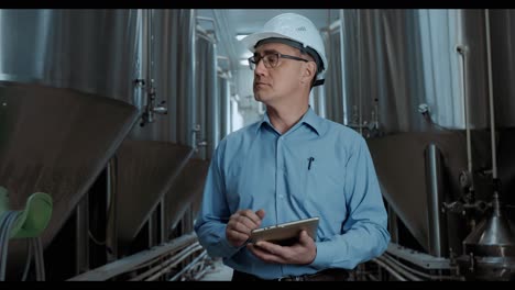 engineer inspecting brewery equipment