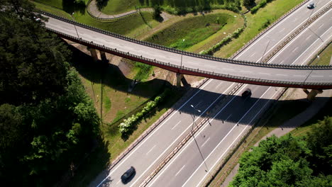 aerial birds eye shot of cars and trucks driving on highway during sunny day