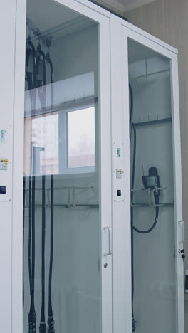 glass wardrobe with medical tools in clinic. surgical instruments in the operating room. medical equipment. vertical video