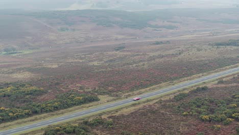 toma aérea de drones rastreando auto en carretera abierta