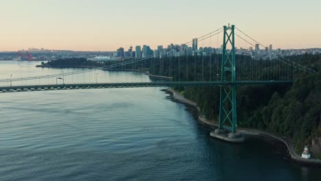 Dolly-Drone-Aerial-Shot-at-Lions-Gate-Bridge-moving-side-the-side-as-car-is-passing-by-during-sunset