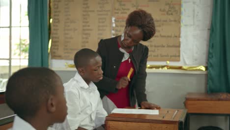 teacher explaining the instructions to students in a classroom in africa